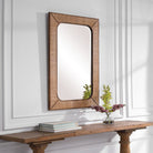 Tamera Accent Mirror on a white wall above a table at Addison West