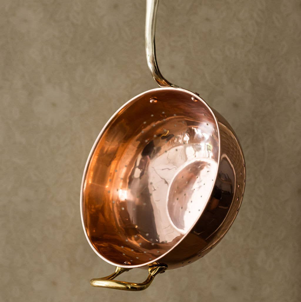 Galley and Fenn Copper Colander on a beige background at Addison West