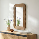 Dance Accent Mirror on a white wall above a table at Addison West