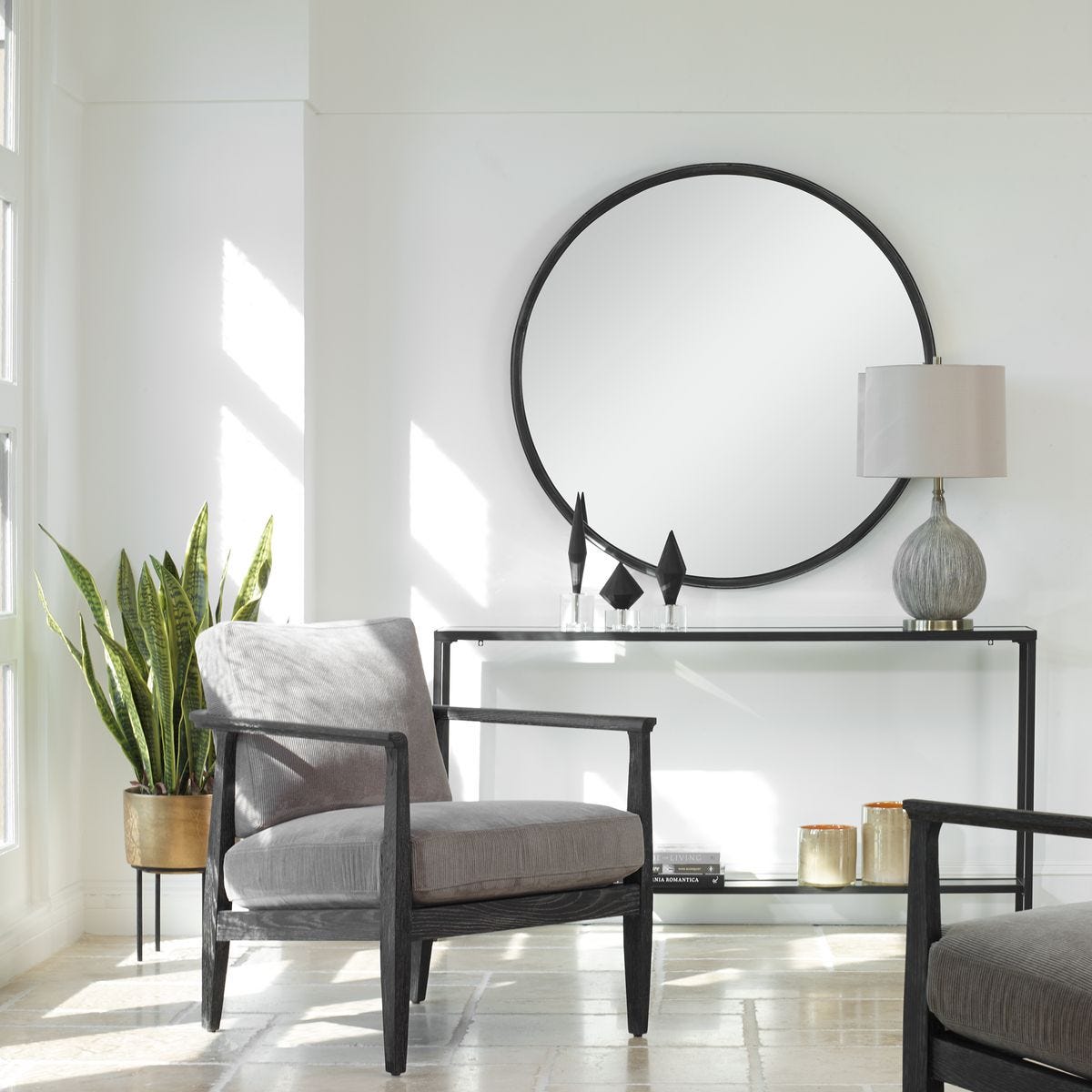 Dawsyn Round Mirror on a white wall above a table at Addison West
