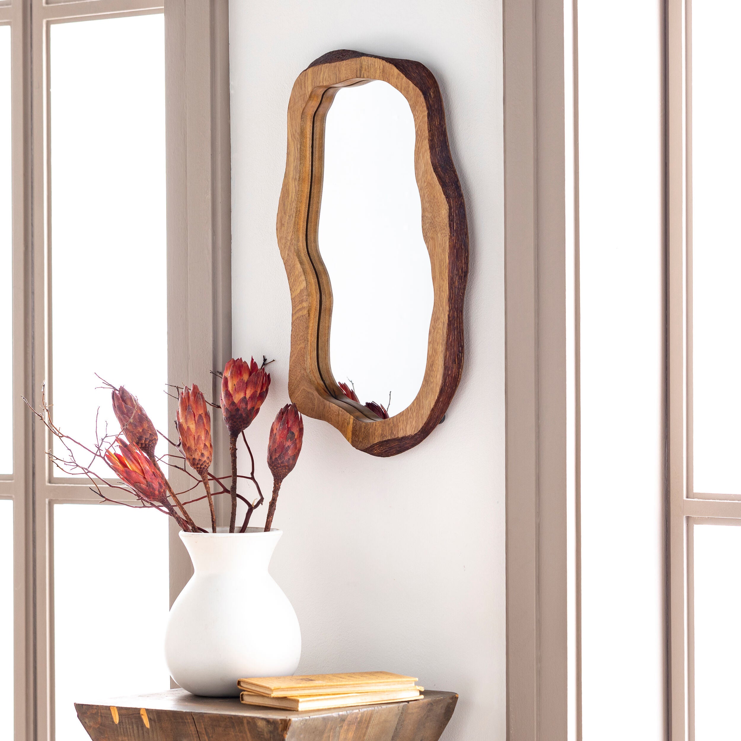 Edge Accent Mirror No. 3 on a white wall above a table at Addison West