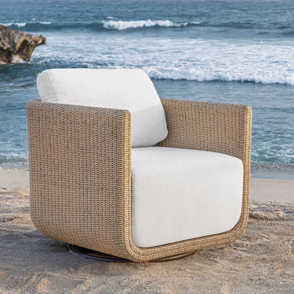 Saylor Outdoor Swivel Lounge Chair on a beach at Addison West