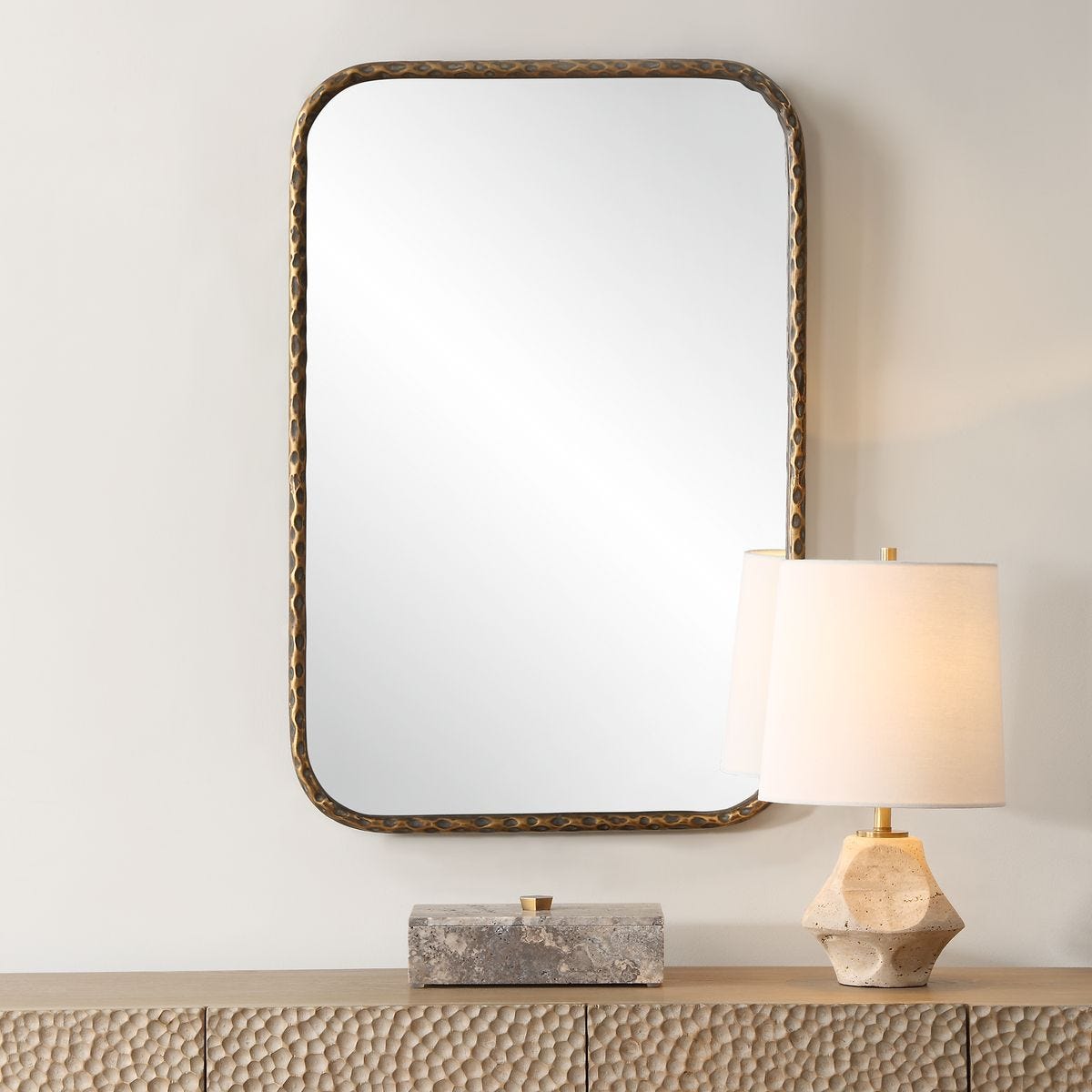 Knoxley Vanity Accent Mirror on a beige wall above a table at Addison West