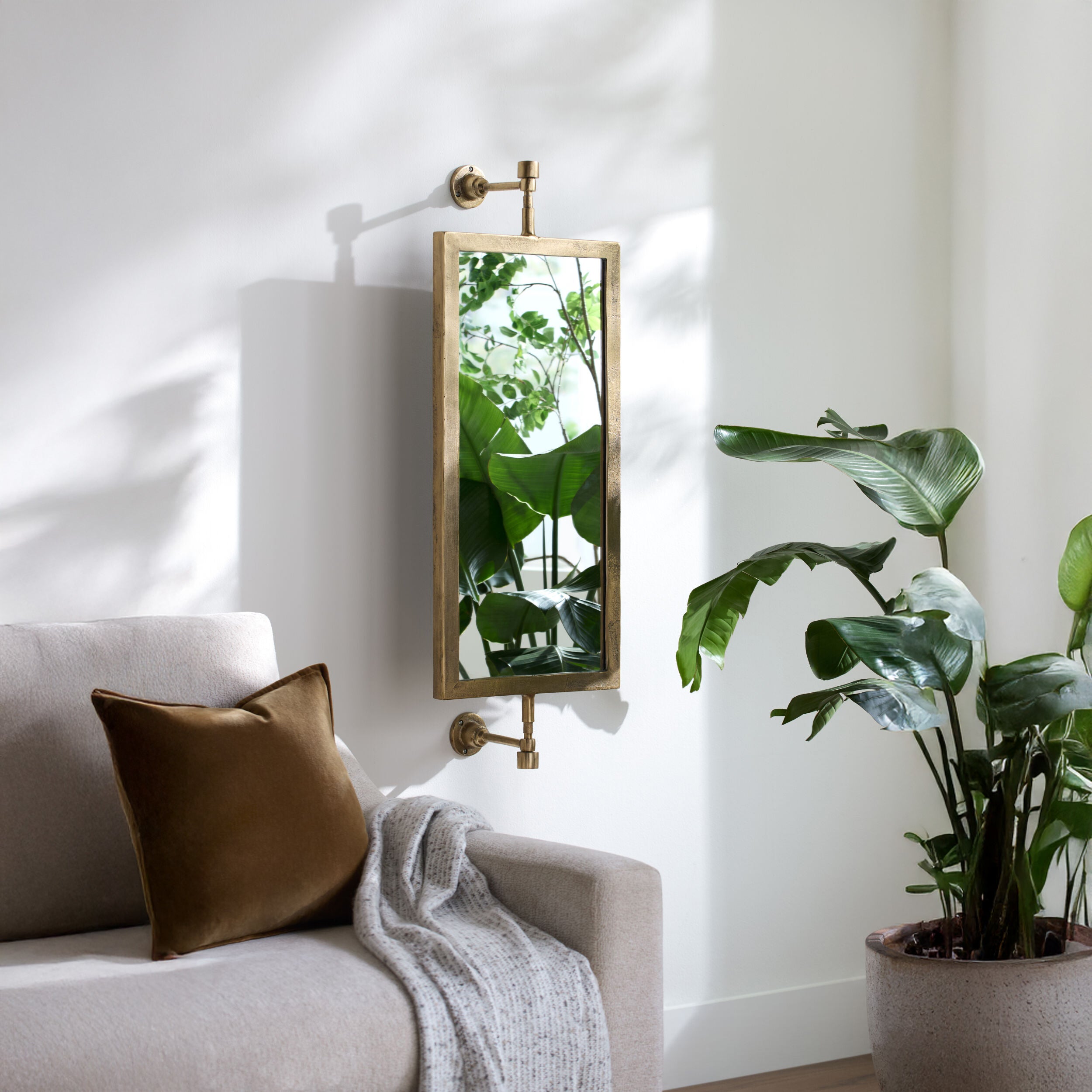 Emmeline Accent Mirror on a white wall in a living room at Addison West
