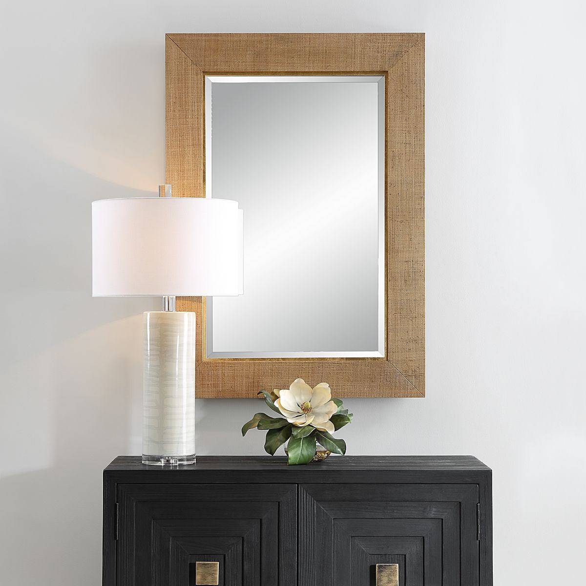 Buxley Accent Mirror on a white wall above a table at Addison West