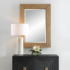 Buxley Accent Mirror on a white wall above a table at Addison West