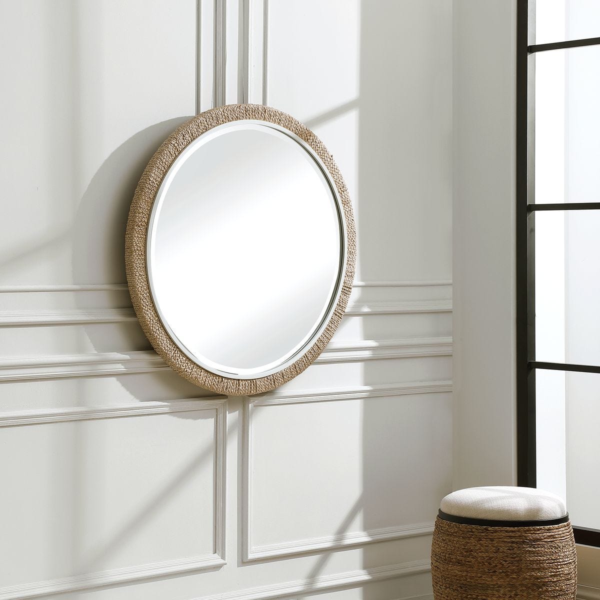 Carsten Round Accent Mirror on a white wall in a living room at Addison West