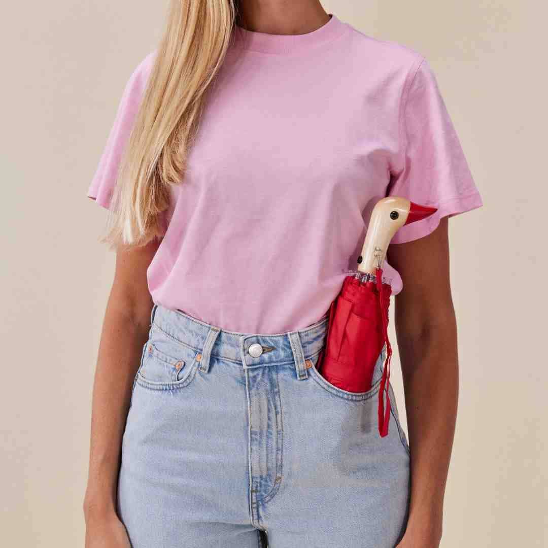 Person holding Original Duckhead Red Eco-Friendly Umbrella on a beige background at Addison West