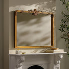 Highclere Mantel Mirror on a beige wall above a mantel at Addison West