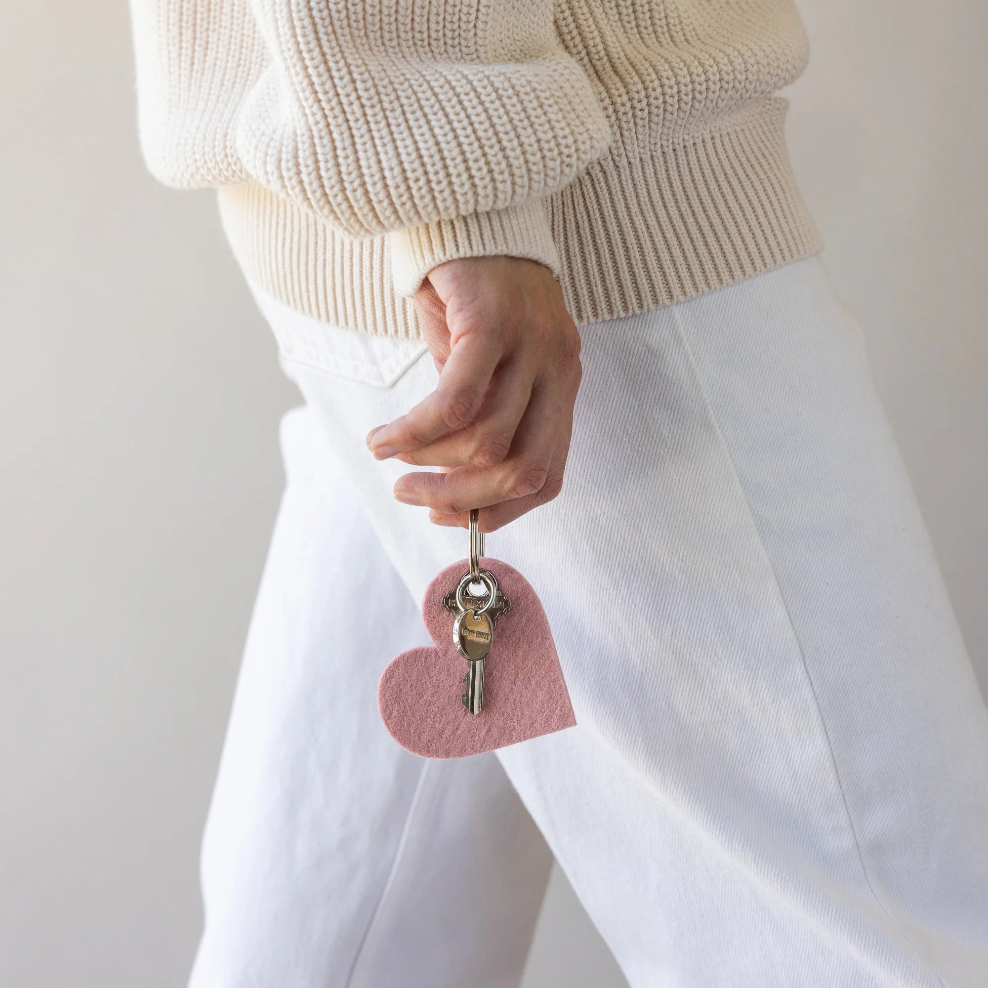 Graf Lantz Merino Wool Heart Key Fob in Rock Salt on a white background with a model at Addison West