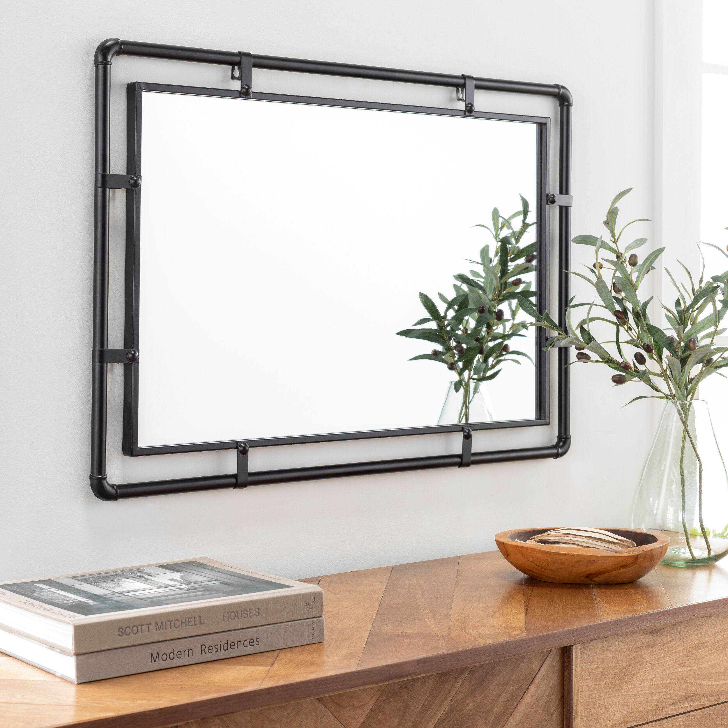 Indus Accent Mirror on a white wall above a table at Addison West
