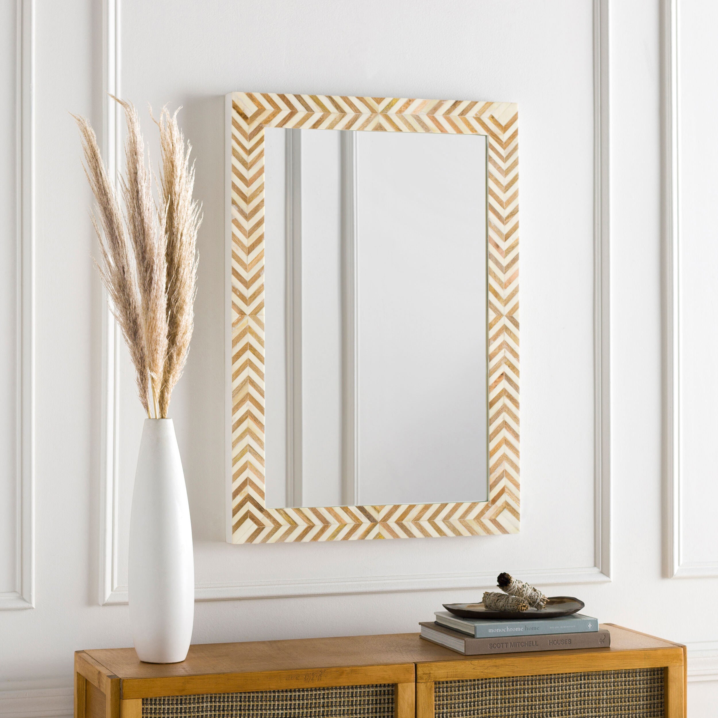 Kathryn Accent Mirror on a white wall above a table at Addison West