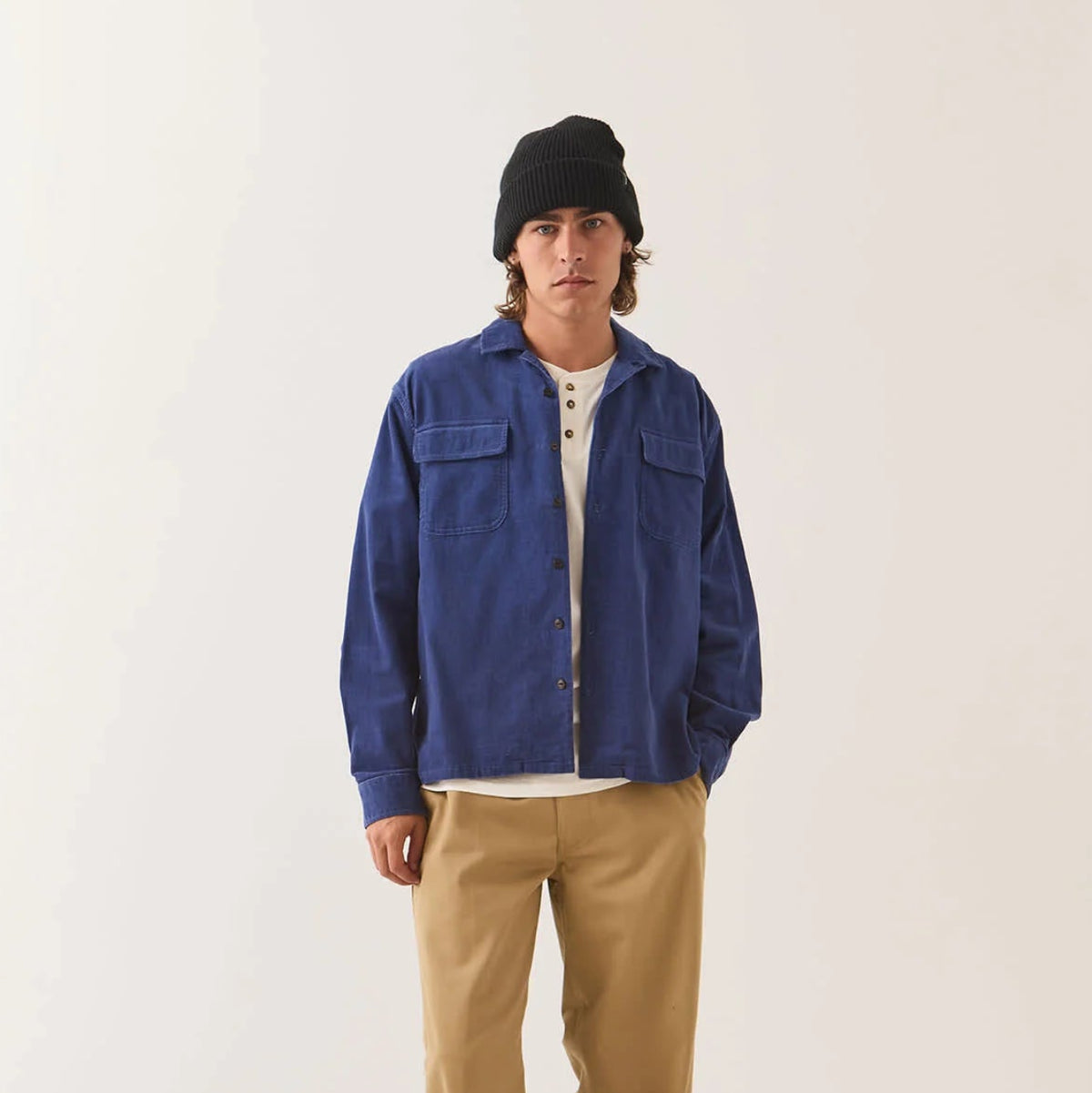 Male model wearing Brixton Men's Century Overshirt in Blue & Navy Shadow on plain background.