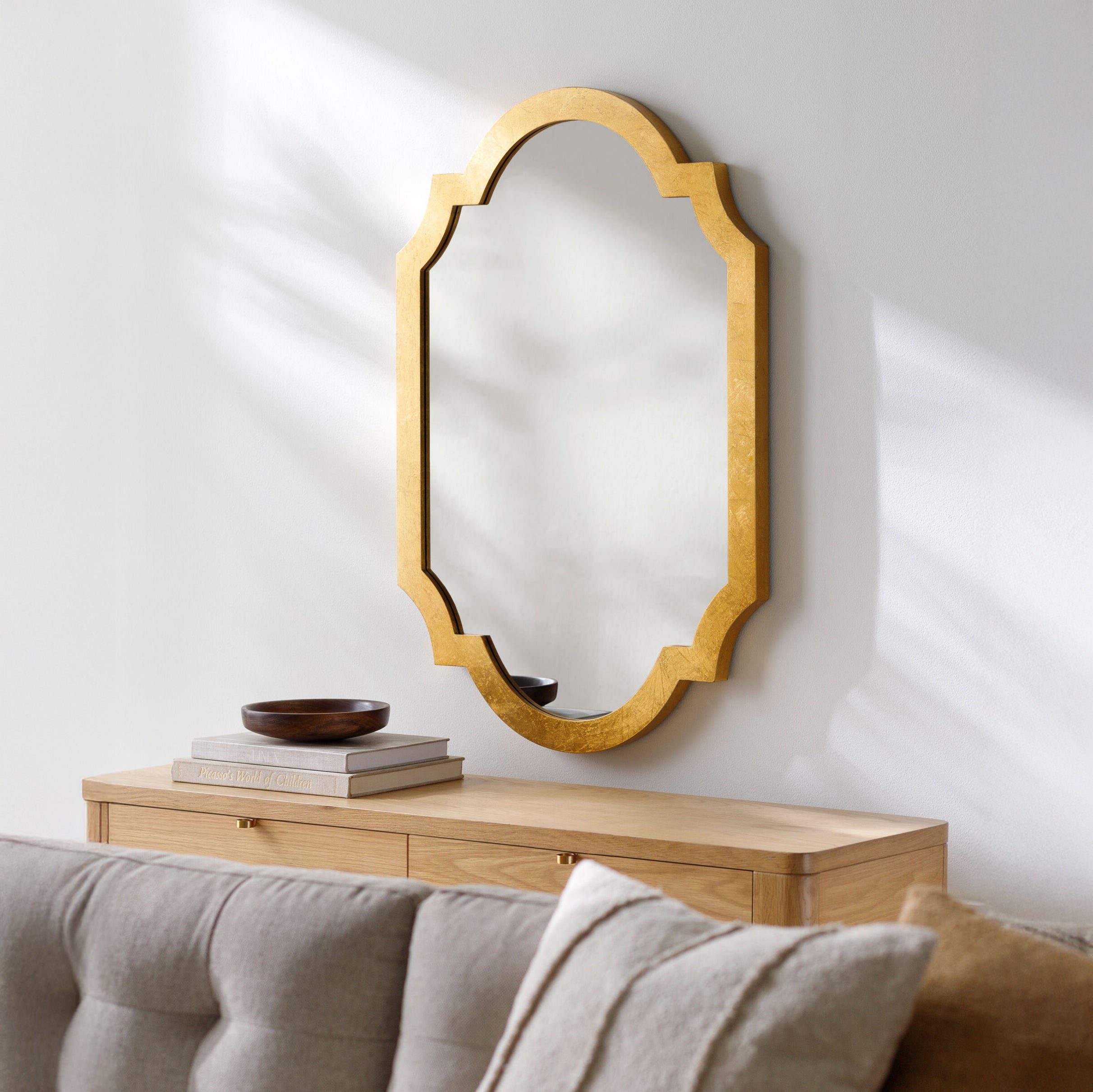 Norway Accent Mirror on a white wall above a table at Addison West