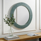 Natalia Accent Mirror on a white wall above at table at Addison West