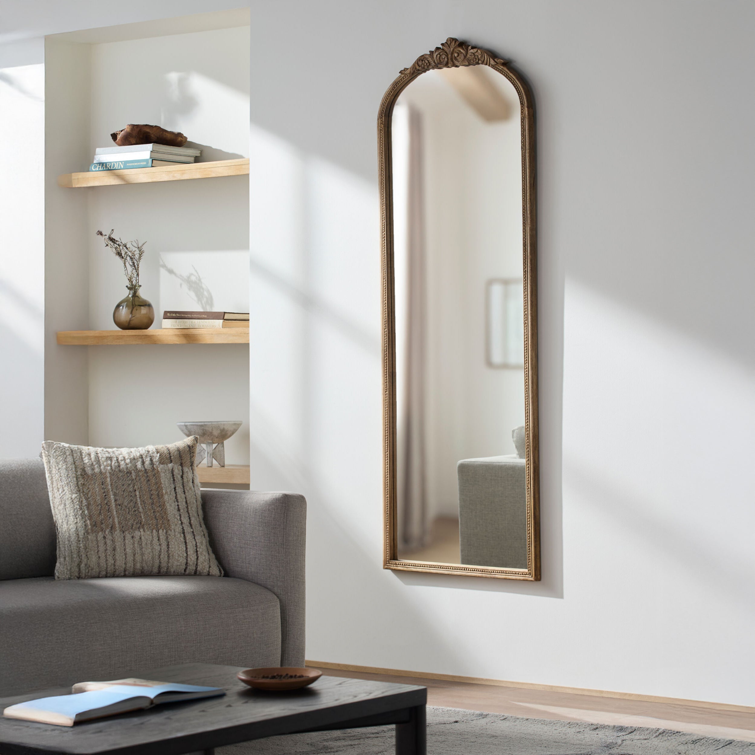 Noya Full Length Mirror in Natural Finish on a white wall in a living room at Addison West