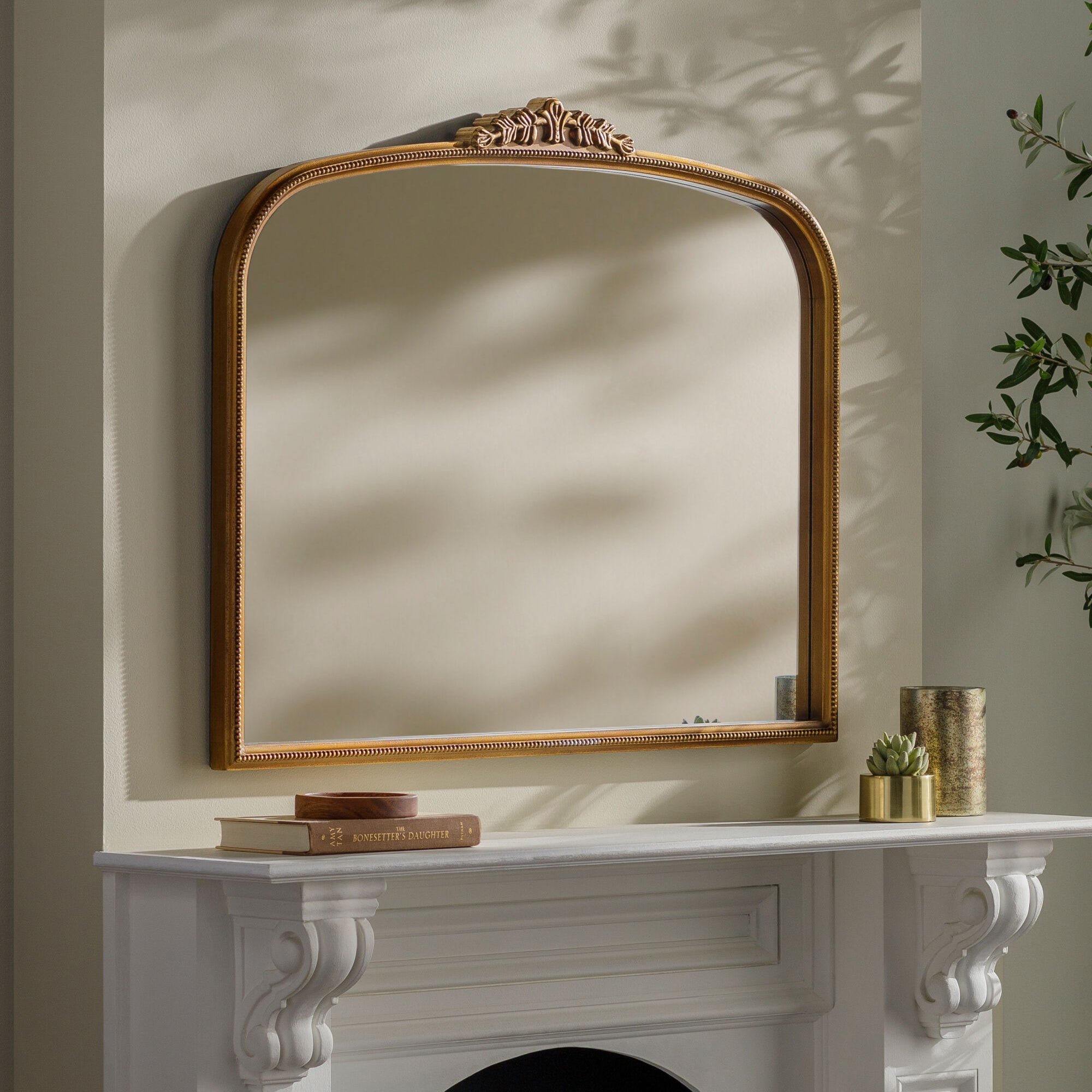 Arrendale Mantel Mirror on a beige wall above a mantel at Addison West