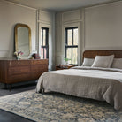 Enya Accent Mirror on a beige wall in a bedroom at Addison West