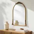 Aarlen Accent Mirror on a white wall above a table at Addison West