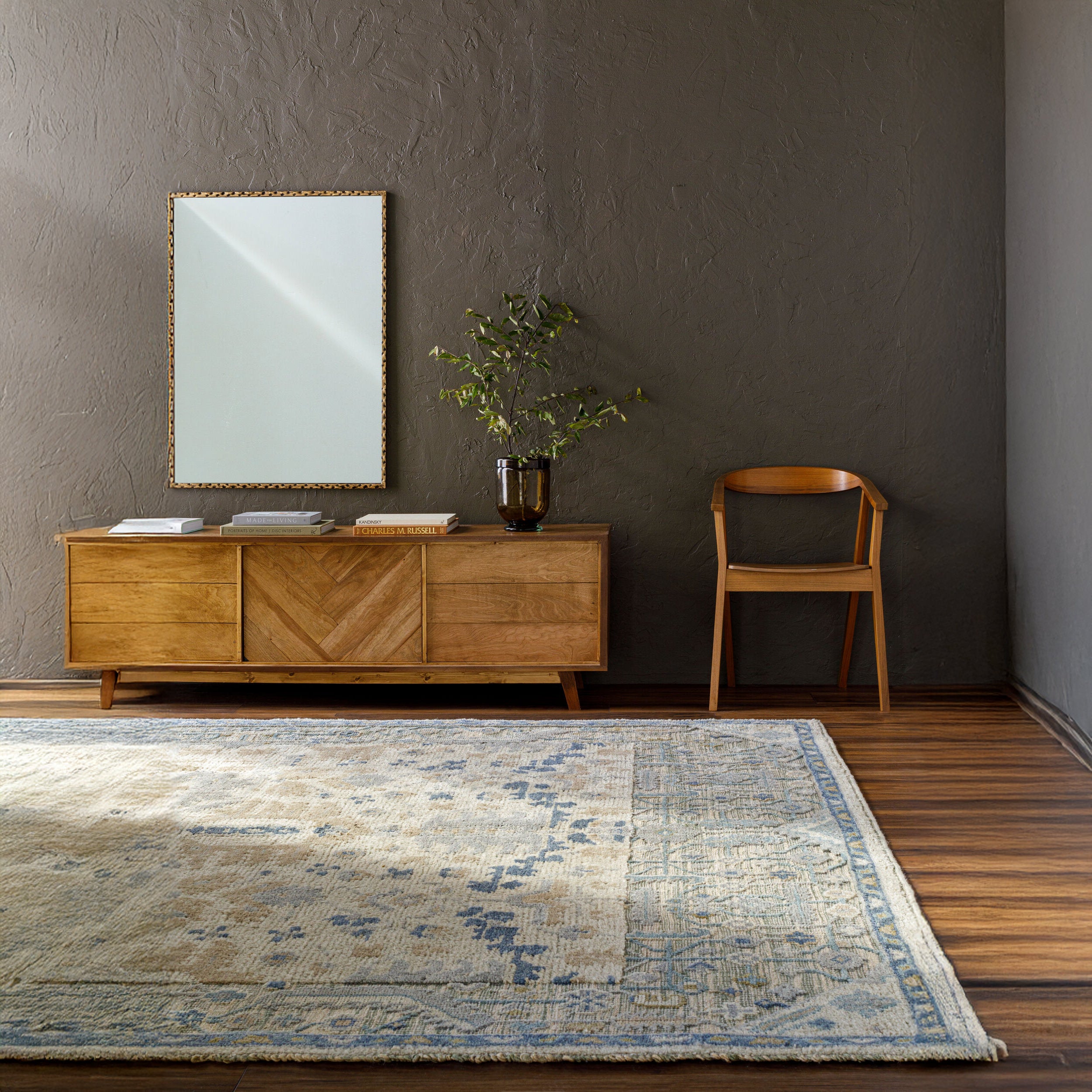 Alchemist Accent Mirror on a dark brown wall in a living room at Addison West