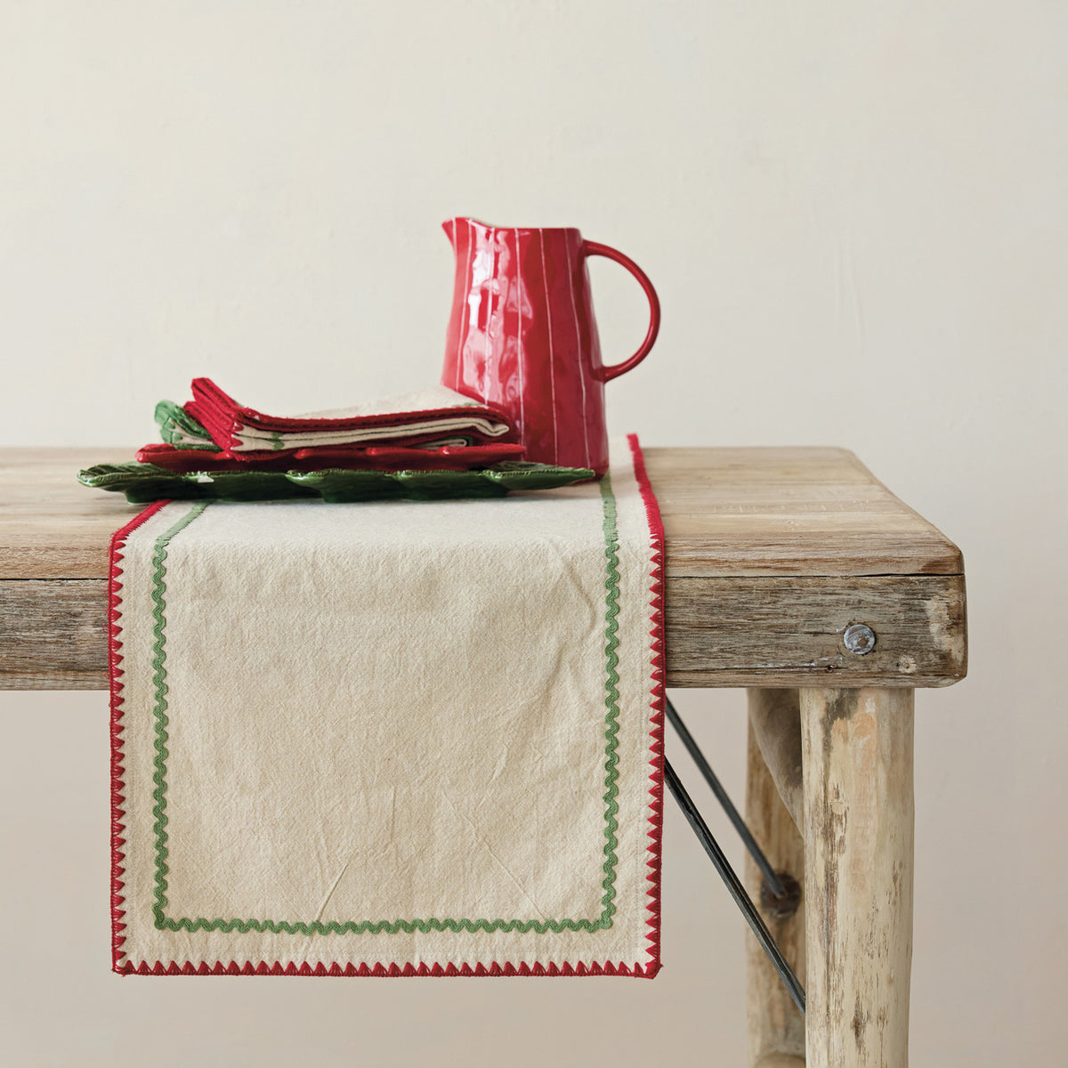 Holiday Ric Rac Trim Table Runner on a beige background at Addison West