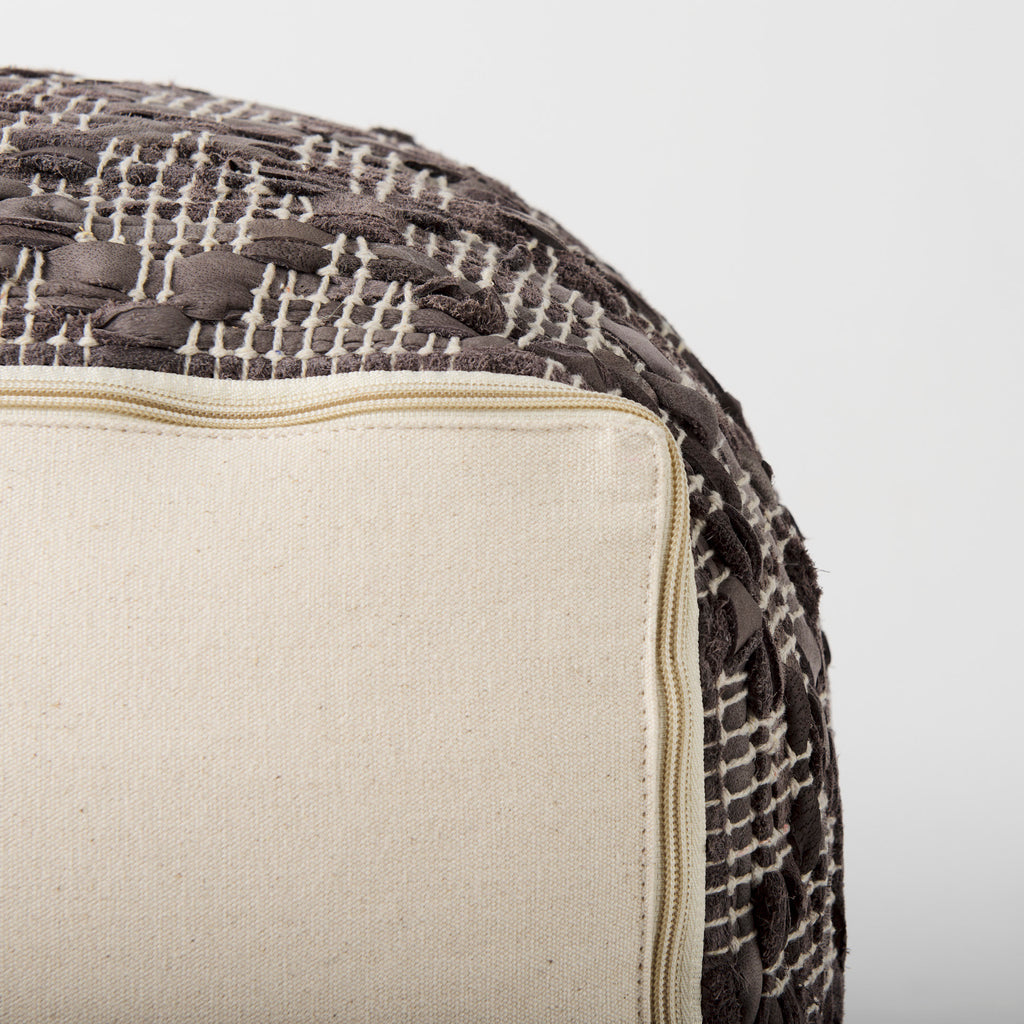 Botton zipper accent of Grey square pouf with cotton and leather accents in geometric pattern on a white background
