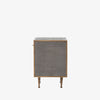 Side view of Grey shagreen nightstand with brass trim accents by four hands furniture on a white background