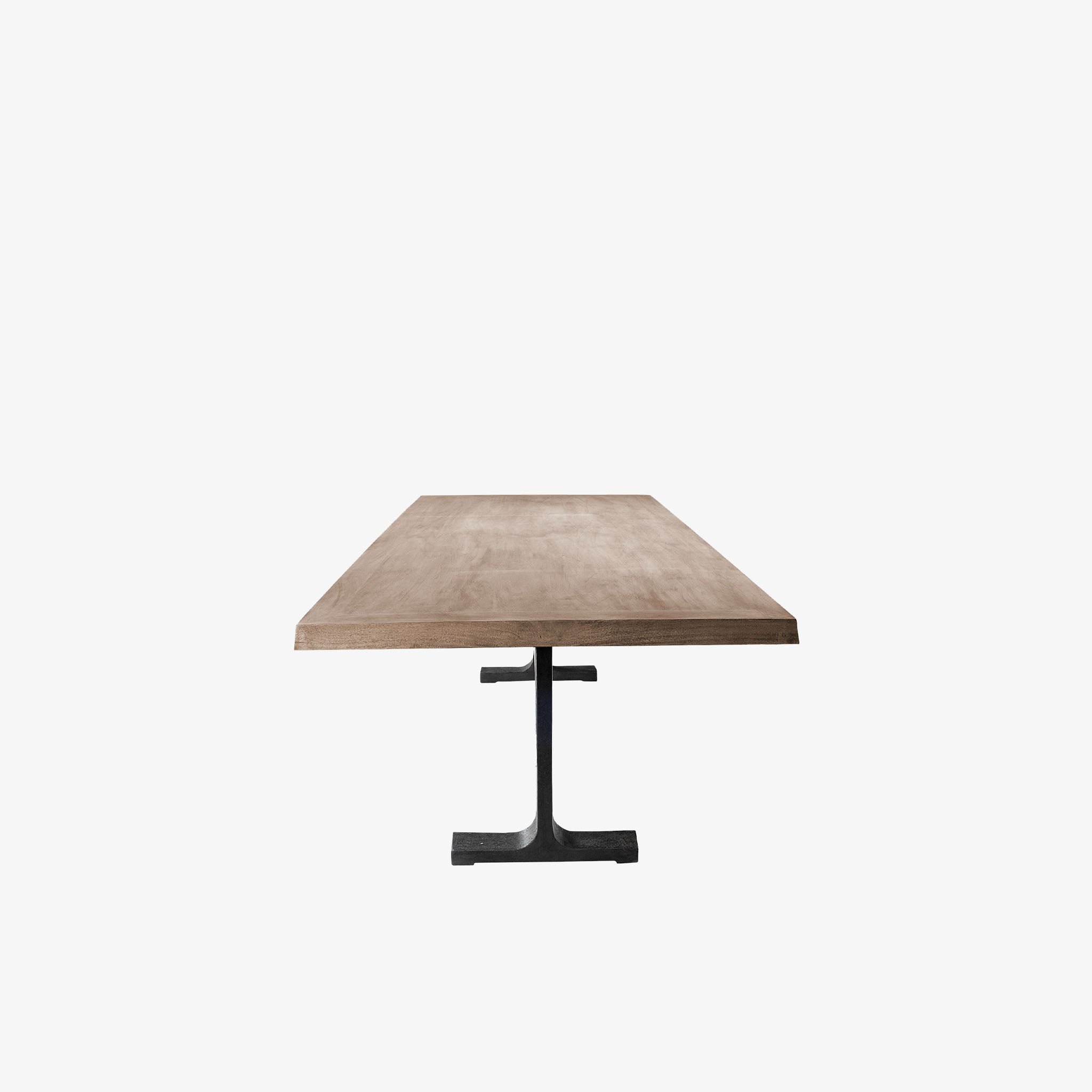 Large rectangular wood dining table with trestle style iron base on a white background