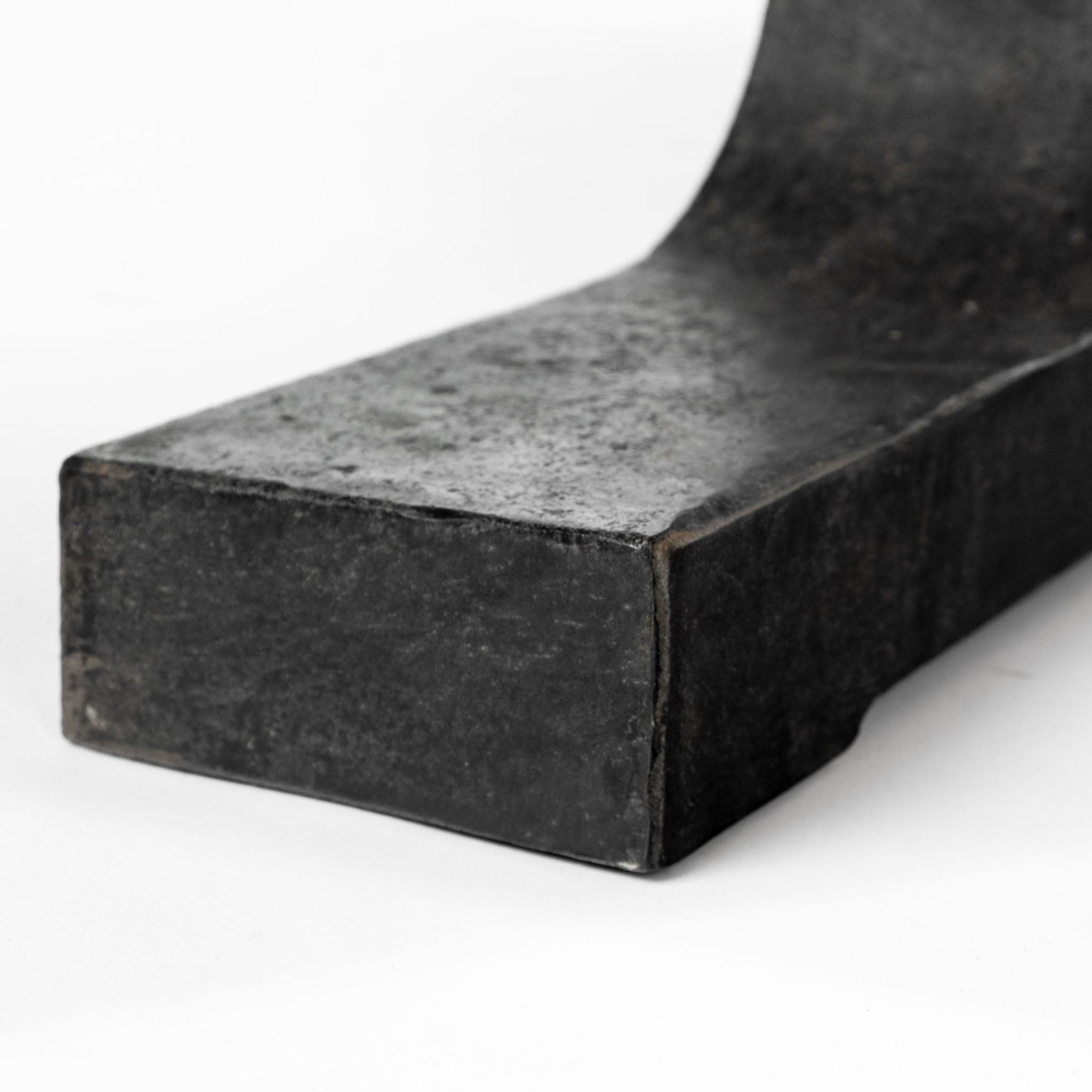 Large rectangular wood dining table with trestle style iron base on a white background