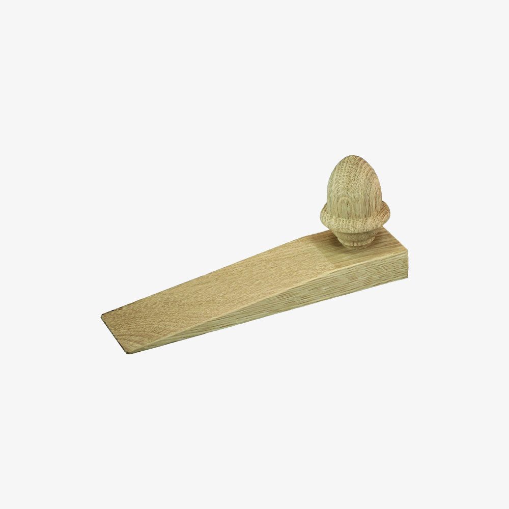 Oak wood door wedge with acorn handle on a white background