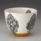 Laura Zindel artichoke bowl with amber glaze accent on a grey background