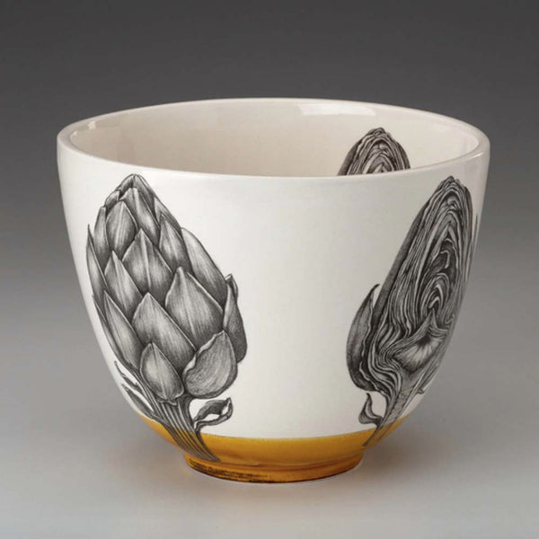 Laura Zindel artichoke bowl with amber glaze accent on a grey background