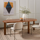 Dining room with wood table and cream rug  with Four Hands Brand Astrud dining chair with pewter fabric upholstery and iron legs around table