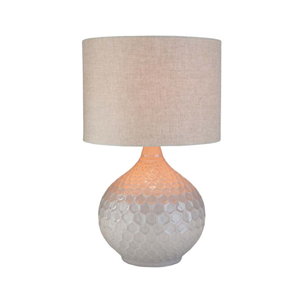 Surya Blakey table lamp with round white base and linen shade on a white background