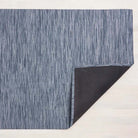 Chilewich bamboo woven floor mat in rain navy blue on a light wood floor