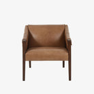 Four Hands Furniture brand Bauer chair in taupe leather with stained wood legs and leather buckled straps on a white background