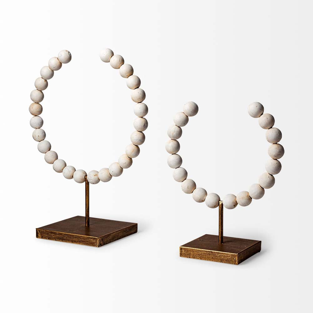 Mercana beaded broken sphere object in white with gold base on white background