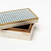 Close up of Decorative box with blue and white geometric bone inlay top with brass trim