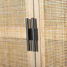 Close up of Four Hands Furniture brand caprice sideboard in light wood with four cane doors and iron handles