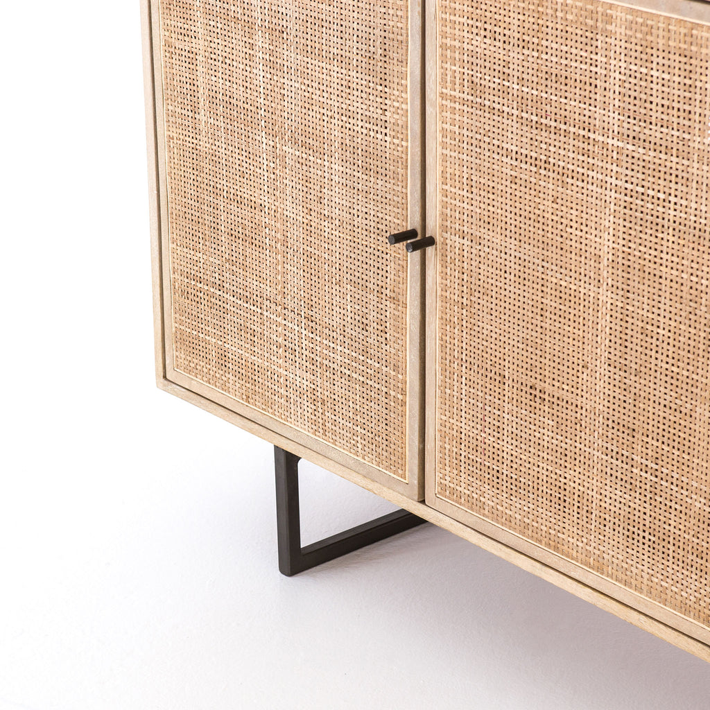 Close up of doors on Four Hands furniture brand Carmel side board with four cane doors on a white background