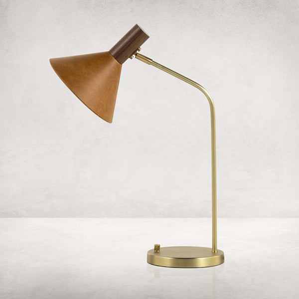 Four hands brand Cullen task lamp in brass with leather shade and walnut accents on a white background