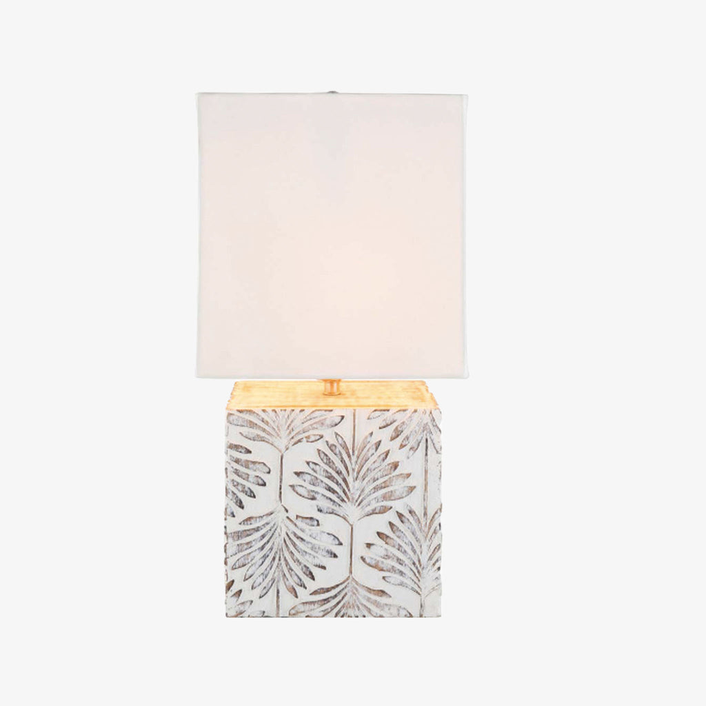 Surya brand Dax table lamp with whitewashed square wood base with leaf pattern and square white shade on a white background