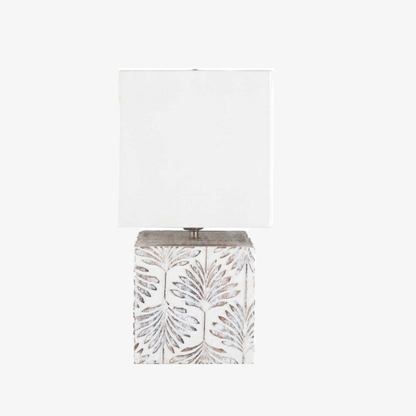 Surya brand Dax table lamp with whitewashed square wood base with leaf pattern and square white shade on a white background