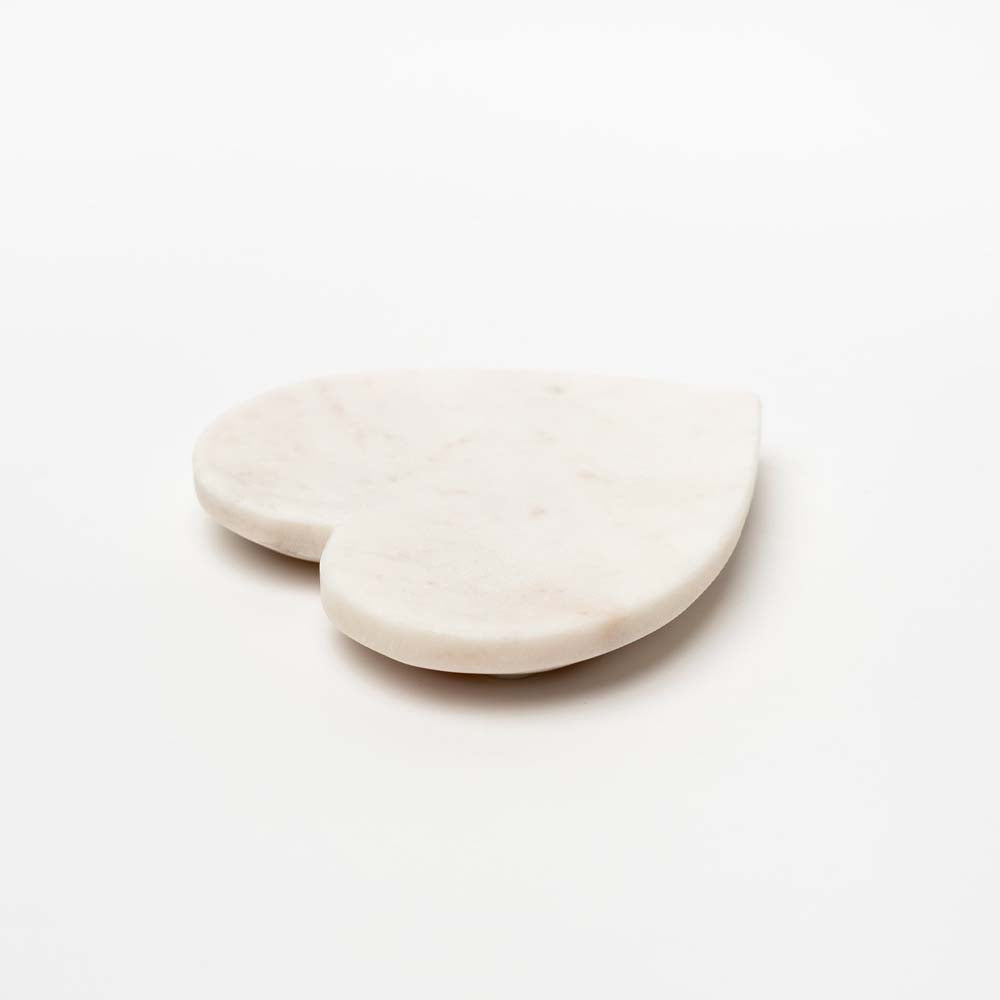 Small white marble heart dish on a white background