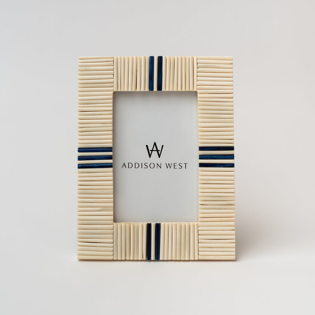 Picture frame with white bone inlay and navy blue accents on a white background