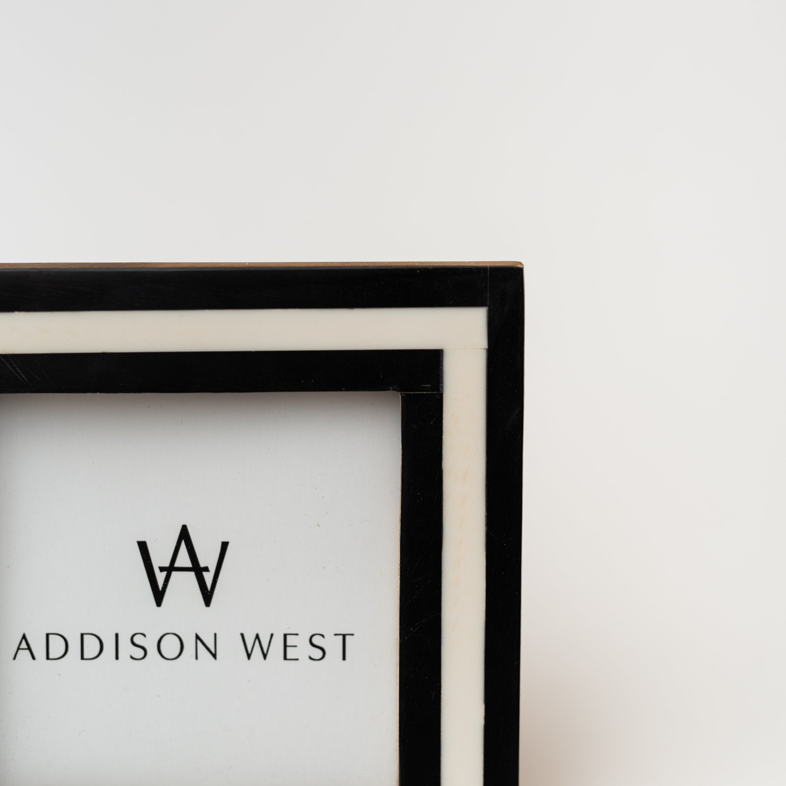 Close up of edge on Black and white picture frame on a white background