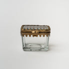 Rectangular beveled glass box with brass snap lid on a white background