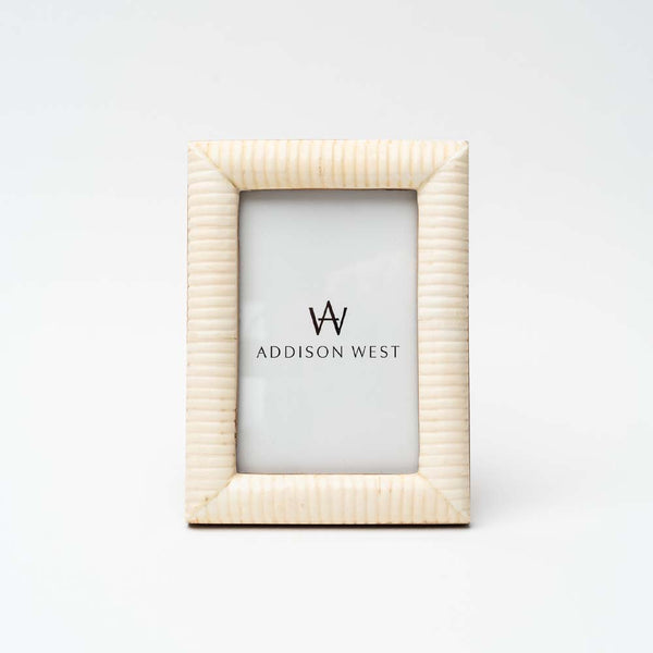 White picture frame for 4x6 photo on a white background.