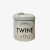 White tin dispenser with lid that says garden twine on front in black letters on a white background