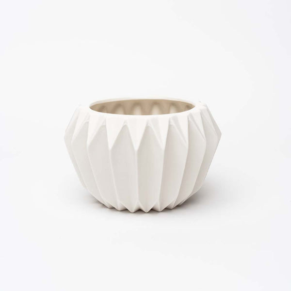White stoneware planter with fluted sides on a white background